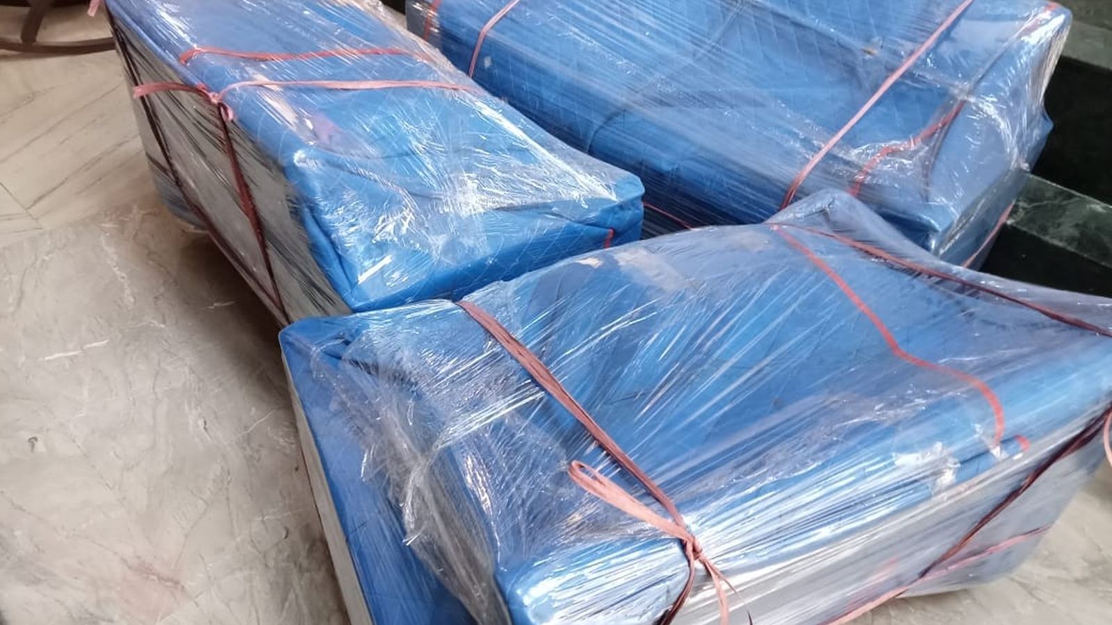 Furniture wrapped in protective sheets for safe relocation